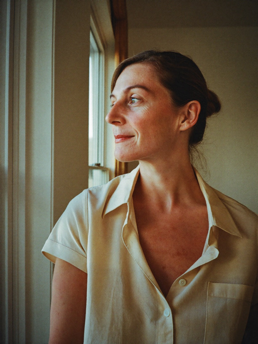 A woman in her 50s at home in soft natural light